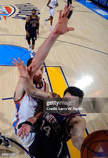 Eduardo Najera of the New Jersey Nets goes to the basket against Nick Collison of the Oklahoma City Thunder at the Ford Center on January 26, 2009 in...