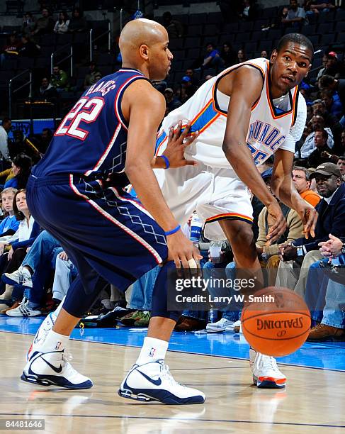 Jarvis Hayes of the New Jersey Nets tries to block a pass against Kevin Durant of the Oklahoma City Thunder at the Ford Center on January 26, 2009 in...