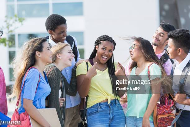 teenage girl with multi-ethnic friends outside school - reputation stock pictures, royalty-free photos & images