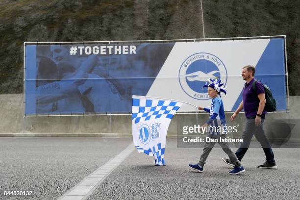 Fans arrive at the stadium prior to the Premier League match between Brighton and Hove Albion and West Bromwich Albion at Amex Stadium on September...