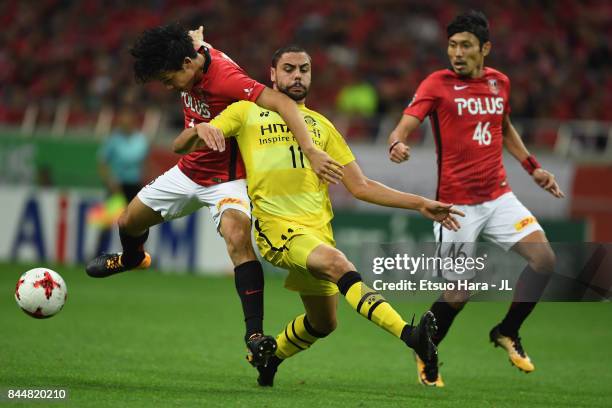 Diego Oliveira of Kashiwa Reysol and Wataru Endo of Urawa Red Diamonds compete for the ball during the J.League J1 match between Urawa Red Diamonds...
