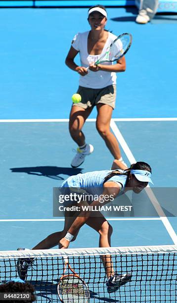 Peng Shuai of China and partner Hsieh Su-Wei of Taiwan return the ball to Venus and Serena Williams of the US during their women's doubles tennis...