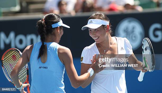 Peng Shuai of China and partner Hsieh Su-Wei of Taiwan react in their game aganst Venus and Serena Williams of the US during their women's doubles...