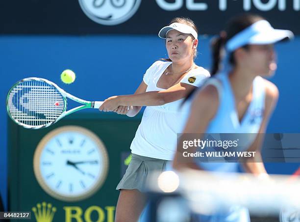 Peng Shuai of China and partner Hsieh Su-Wei of Taiwan return the ball to Venus and Serena Williams of the US during their women's doubles tennis...
