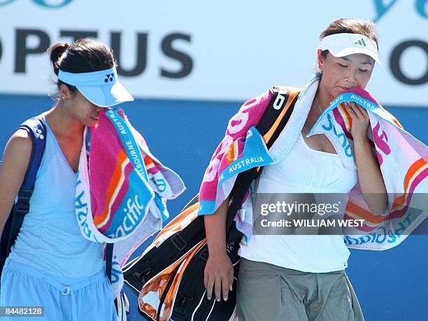 Peng Shuai of China and partner Hsieh Su-Wei of Taiwan leave the court after their game against Venus and Serena Williams of the US after their...