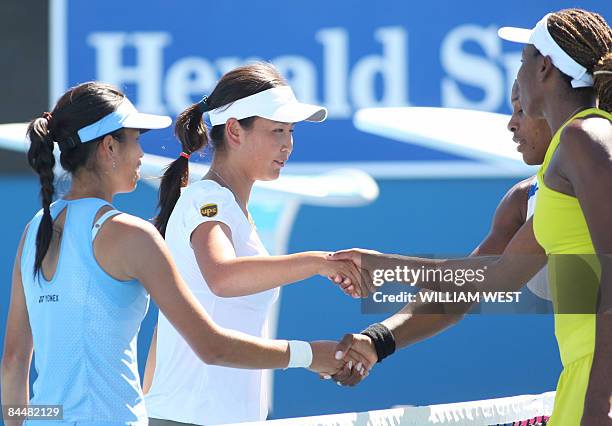 Peng Shuai of China and partner Hsieh Su-Wei of Taiwan shake hands with Venus and Serena Williams of the US after their women's doubles tennis match...
