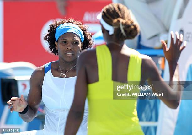 Venus and Serena Williams of the US celebrate defeating Peng Shuai of China and partner Hsieh Su-Wei of Taiwan after their women's doubles tennis...
