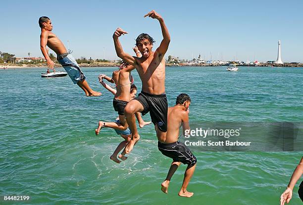 Boys jump of the pier at St Kilda beach as a heatwave hits Melbourne on January 27, 2009 in Melbourne, Australia. The temperature today is estimated...