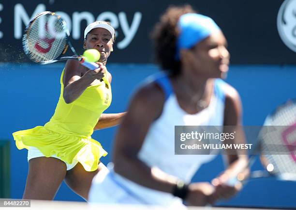 Venus and Serena Williams of the US return the ball to Peng Shuai of China and partner Hsieh Su-Wei of Taiwan during their women's doubles tennis...