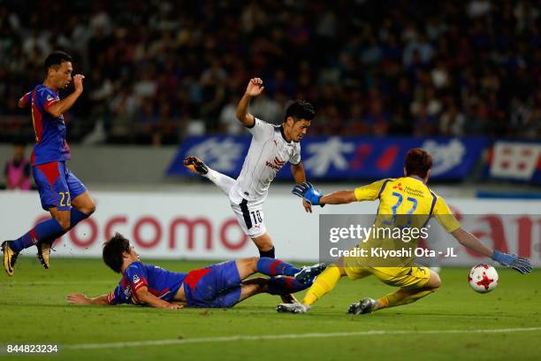 Hotaru Yamaguchi of Cerezo Osaka is tackled by FC Tokyo player during the J.League J1 match between FC Tokyo and Cerezo Osaka at Ajinomoto Stadium...