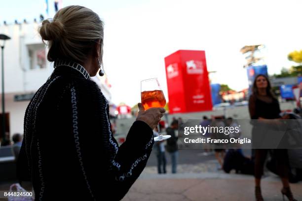 Woman drinks a Spritz at the Lion Bar in front of the Palazzo del Cinema during the 74. Venice Film Festival on September 9, 2017 in Venice, Italy.