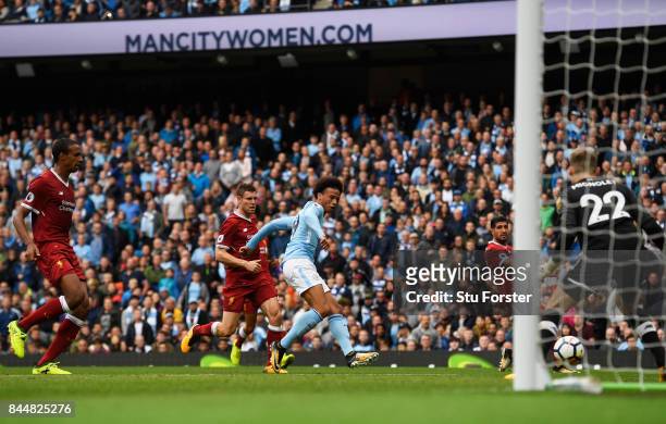 Leroy Sane of Manchester City scores his sides fourth goal past Simon Mignolet of Liverpool during the Premier League match between Manchester City...