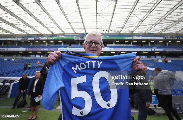 John Motson is presented with a shirt prior to the Premier League match between Brighton and Hove Albion and West Bromwich Albion at Amex Stadium on...