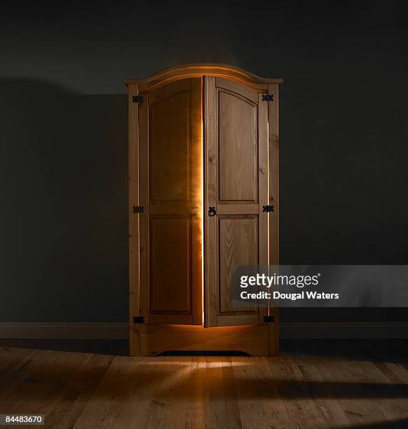 light shining out of wardrobe door. - wardrobe stock pictures, royalty-free photos & images