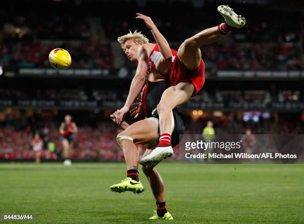 Isaac Heeney of the Swans and Mark Baguley of the Bombers compete for the ball during the AFL Second Elimination Final match between the Sydney Swans...