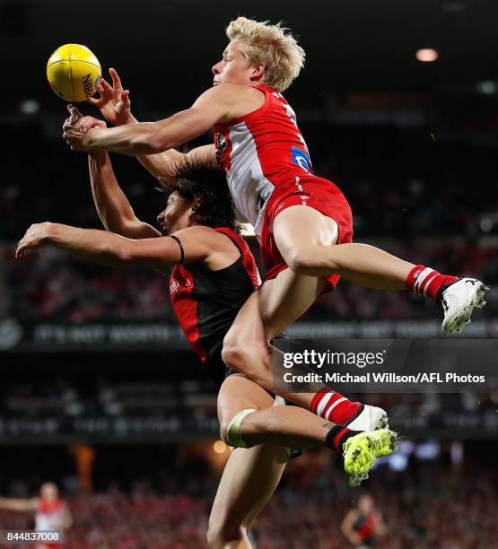 Isaac Heeney of the Swans and Mark Baguley of the Bombers compete for the ball during the AFL Second Elimination Final match between the Sydney Swans...