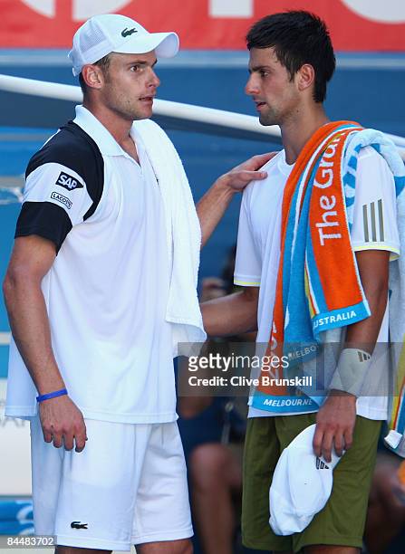 Novak Djokovic of Serbia congratulates Andy Roddick of the United States of America after Djokovic retired from his quarterfinal match during day...