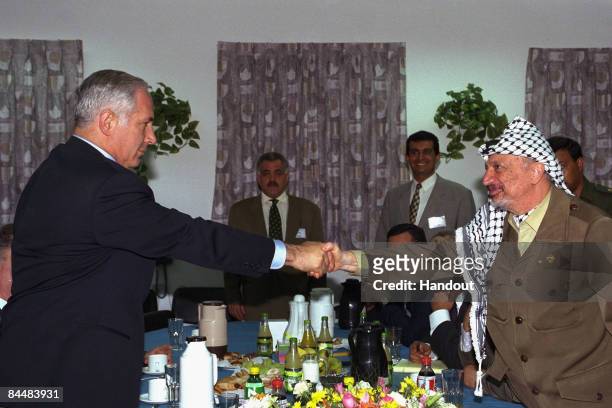 In this Israeli Government Press Office file photo, Israeli Prime Minister Benjamin Netanyahu shakes hands with Palestinian President Yasser Arafat...