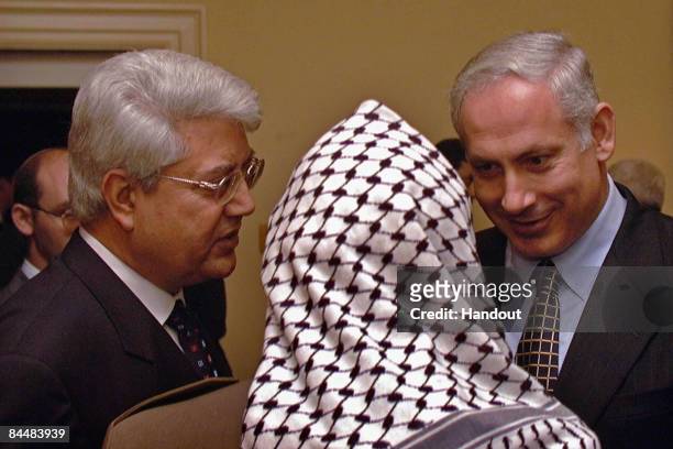 In this Israeli Government Press Office file photo, Prime Minister Benjamin Netanyahu confers with Palestinian President Yasser Arafat as Foreign...
