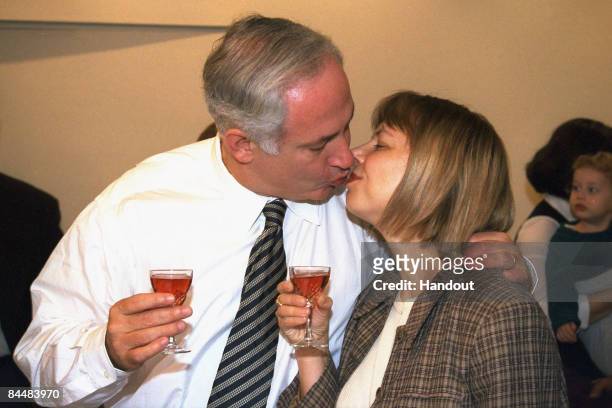 In this Israeli Government Press Office file photo, Prime Minister Benjamin Netanyahu kisses his wife Sara Netanyahu during a surprise 47th birthday...