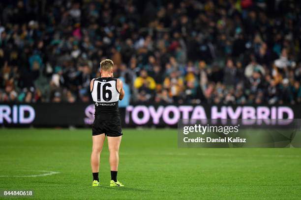 Ollie Wines of the Power stands alone in the middle of the ground after the AFL First Elimination Final match between Port Adelaide Power and West...