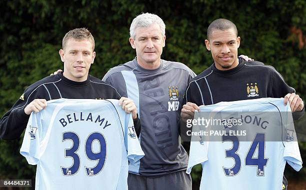 Manchester City's new signings Welsh striker Craig Bellamy and Dutch midfielder Nigel De Jong pose for photographers with Manchester City manager...