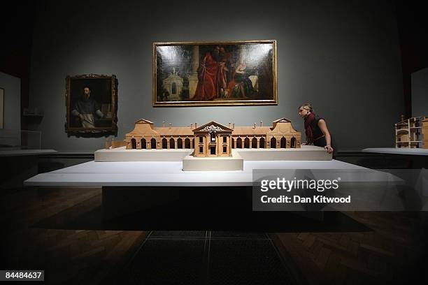An employee stands next to a scale model of 'Villa Barbaro' in front of 'Susanna and the Elders' by Andrea Palladio displayed at the Royal Academy of...
