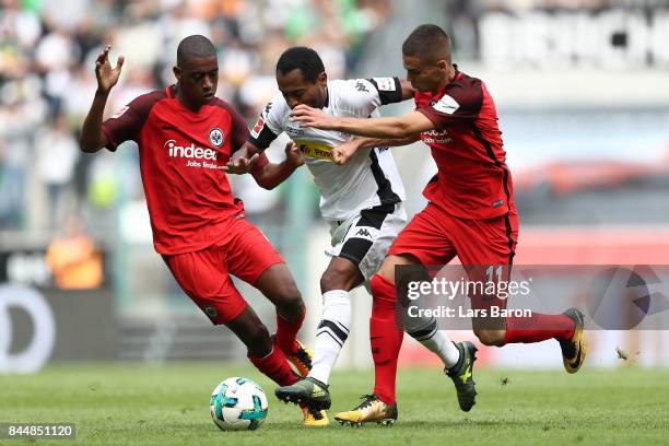 Gelson Fernandes of Frankfurt , Raffael of Moenchengladbach and Mijat Gacinovic of Frankfurt fight for the ball during the Bundesliga match between...