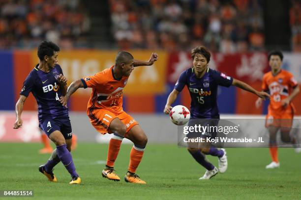 Douglas Tanque of Albirex Niigata controls the ball under pressure of Hiroki Mizumoto and Sho Inagaki of Sanfrecce Hiroshima during the J.League J1...