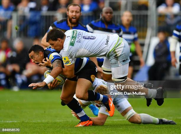 Kahn Fotualii of Bath is tackled by Michael Rhodes and Jackson Wray of Saracens during the Aviva Premiership match between Bath Rugby and Saracens at...