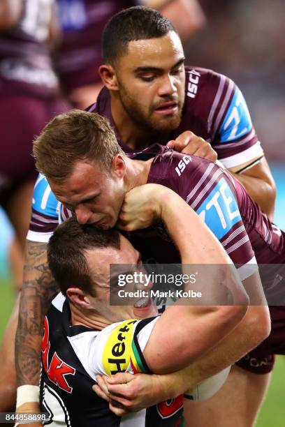 Isaah Yeo of the Panthers is tackled by Daly Cherry-Evans and Dylan Walker of the Sea Eagles during the NRL Elimination Final match between the Manly...