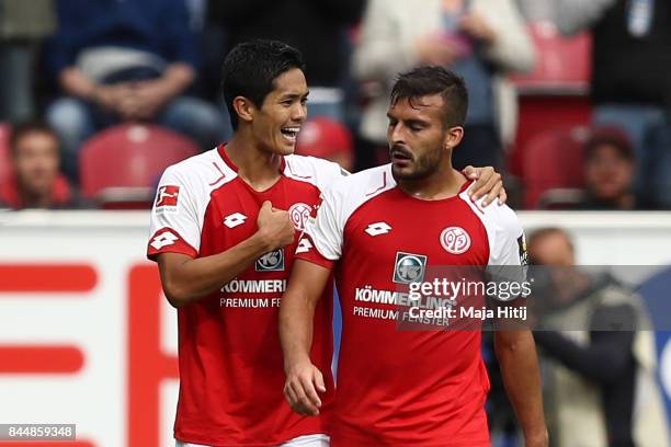 Yoshinori Muto of Mainz celebrates with Giulio Donati of Mainz after he scored his teams first goal to make it 1:1 during the Bundesliga match...