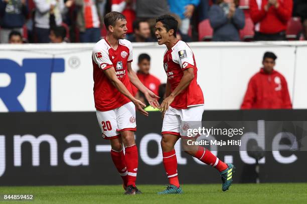 Yoshinori Muto of Mainz celebrates with Fabian Frei of Mainz after he scored his teams first goal to make it 1:1 during the Bundesliga match between...