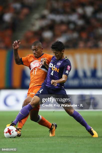 Douglas Tanque of Albirex Niigata and Hiroki Mizumoto of Sanfrecce Hiroshima compete for the ball during the J.League J1 match between Albirex...