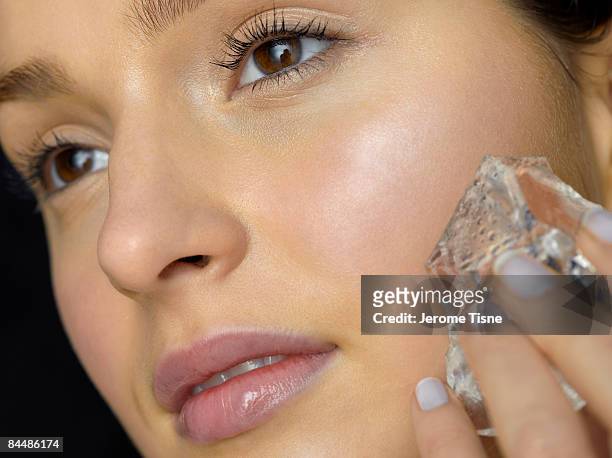 close-up of young woman doing ice treatment - woman ice stock-fotos und bilder