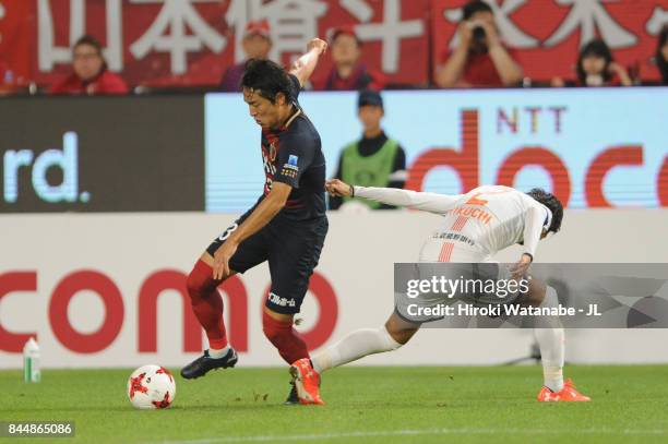 Mu Kanazaki of Kashima Antlers goes past Kosuke Kikuchi of Omiya Ardija during the J.League J1 match between Kashima Antlers and Omiya Ardija at...