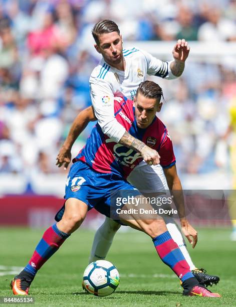 Alex Alegria of Levante UD is challenged by Sergio Ramos of Real Madrid CF during the La Liga match between Real Madrid and Levante at Estadio...