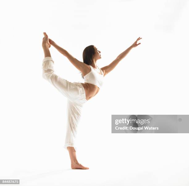 young woman exercising. - lord of the dance pose stock pictures, royalty-free photos & images