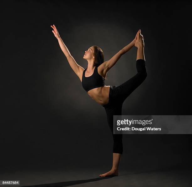 young woman exercising. - lord of the dance pose stock pictures, royalty-free photos & images