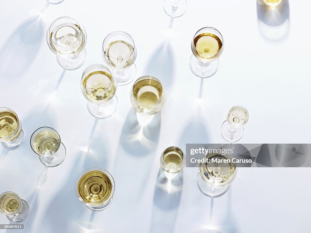 Wine glasses with white wine on white tablecloth