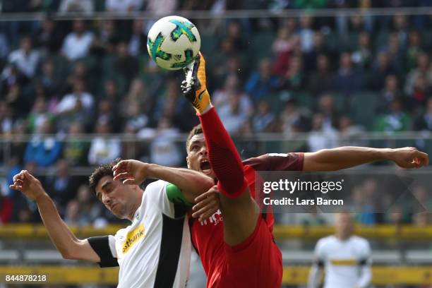 Lars Stindl of Moenchengladbach fights for the ball with Simon Falette of Frankfurt during the Bundesliga match between Borussia Moenchengladbach and...