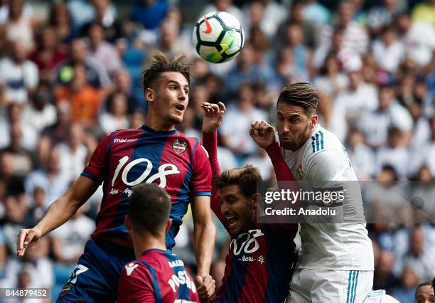 Sergio Ramos of Real Madrid in action against Alex Alegria and Jose Campana of Levante during the La Liga soccer match between Real Madrid and...