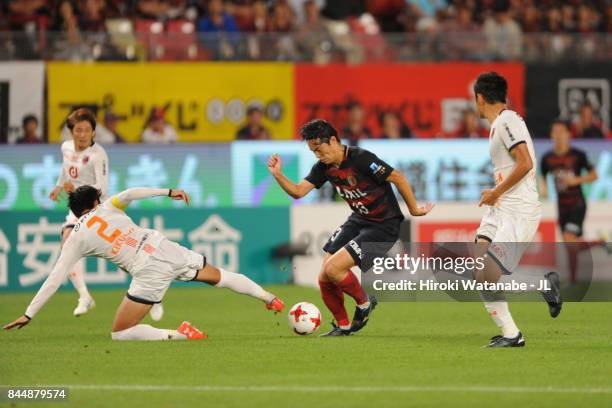 Mu Kanazaki of Kashima Antlers controls the ball under pressure of Kosuke Kikuchi of Omiya Ardija during the J.League J1 match between Kashima...