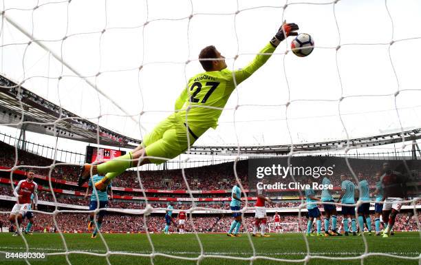 Asmir Begovic of AFC Bournemouth dives to make a save during the Premier League match between Arsenal and AFC Bournemouth at Emirates Stadium on...