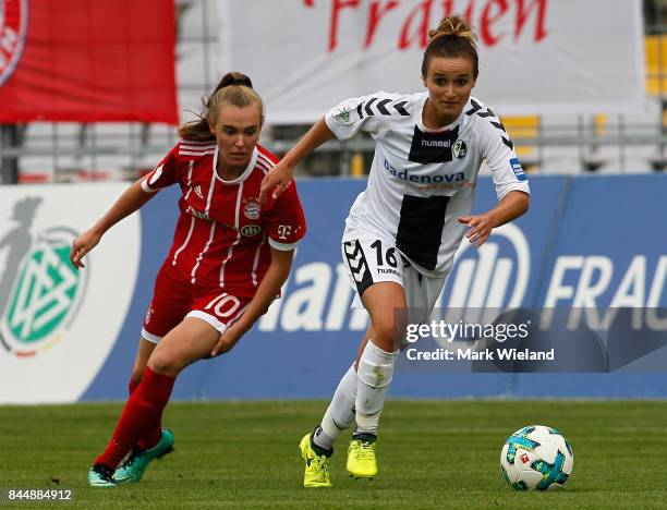 Lina Magull of SC Freiburg and Jill Roord of Bayern Muenchen in action during the women Bundesliga match between Bayern Muenchen and SC Freiburg at...