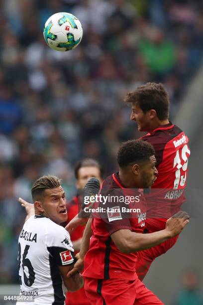 Raul Bobadilla of Moenchengladbach , Simon Falette of Frankfurt and David Abraham of Frankfurt fight for the ball during the Bundesliga match between...
