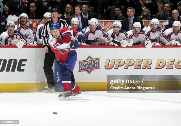 Eastern Conference All-Star Mike Komisarek of the Montreal Canadiens passes the puck under the watchful eyes of Western Conference All-Stars...