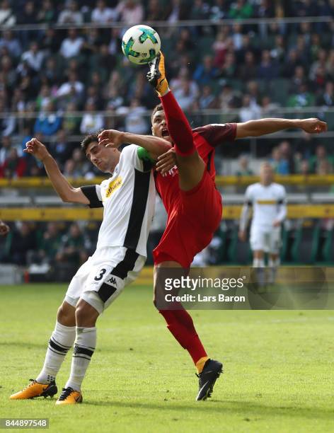 Lars Stindl of Moenchengladbach fights for the ball with Simon Falette of Frankfurt during the Bundesliga match between Borussia Moenchengladbach and...