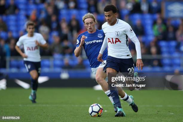 Dele Alli of Tottenham Hotspur takes the ball past Tom Davies of Everton during the Premier League match between Everton and Tottenham Hotspur at...