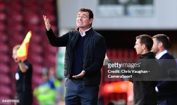 Blackpool manager Gary Bowyer shouts instructions to his team from the technical area during the Sky Bet League One match between Scunthorpe United...